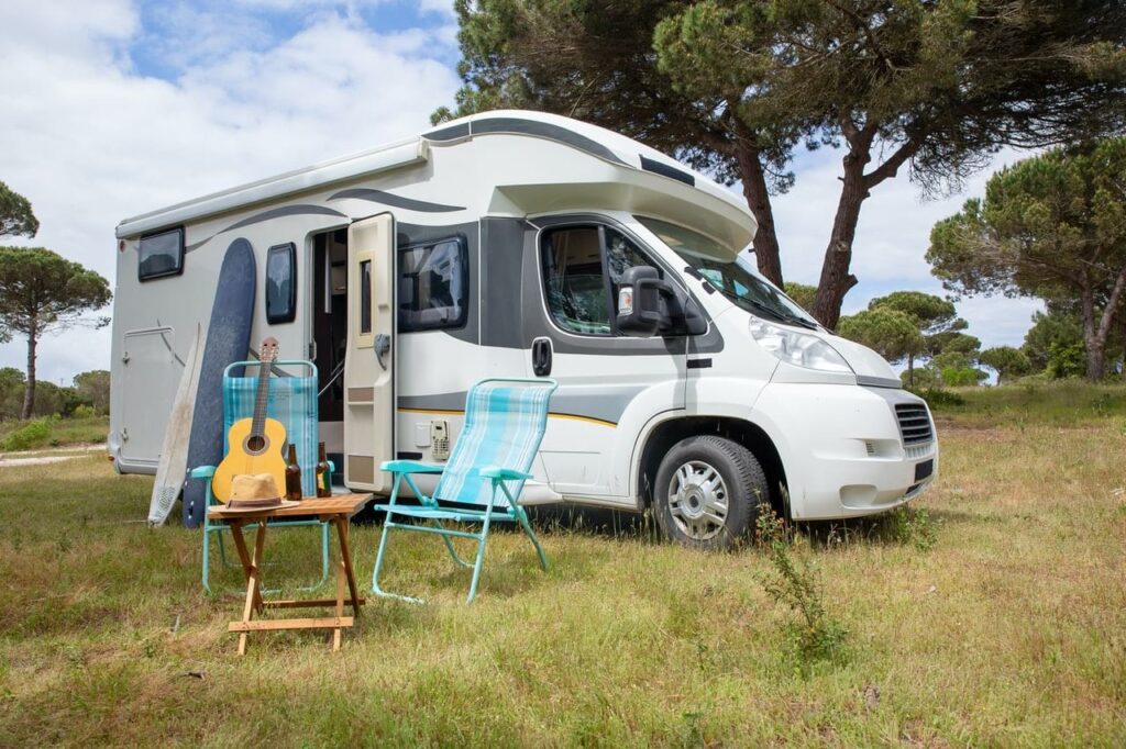 parked campervan with two chairs in front
