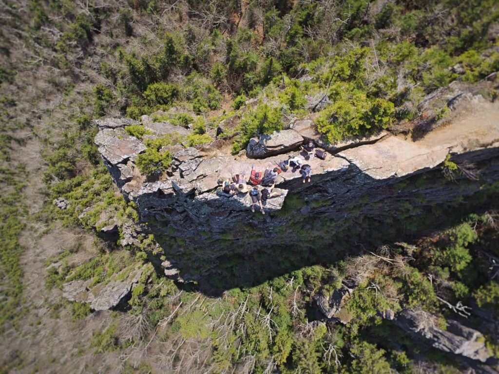 people standing on a cliff
