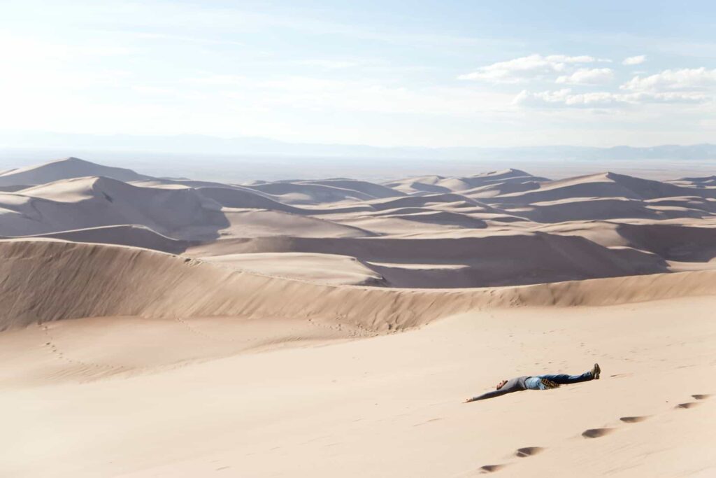 a man lying on sand