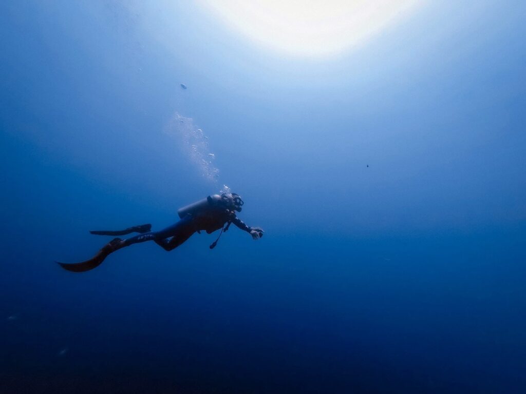 scuba diver in deep blue sea