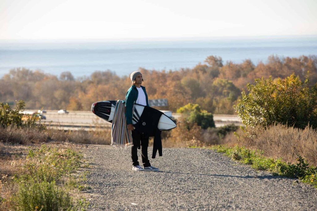 a man carrying a surfboard 