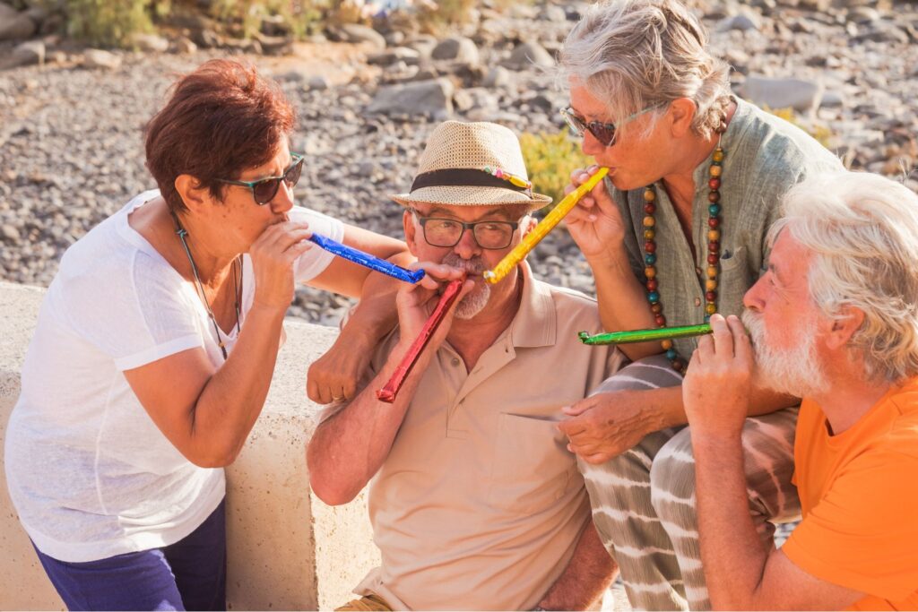elderly people celebrating on a beach 