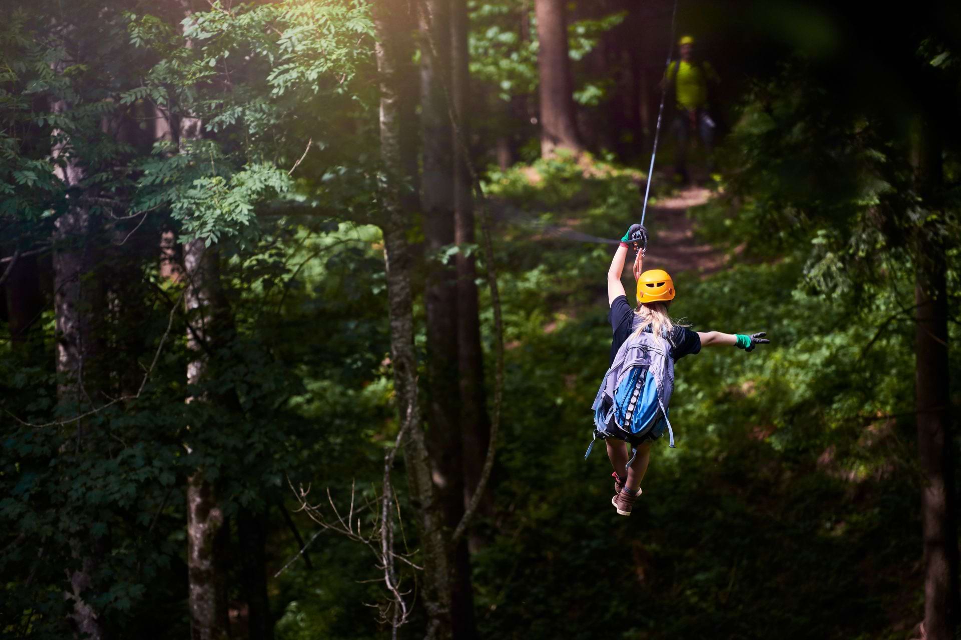 a person zip lining in a jungle