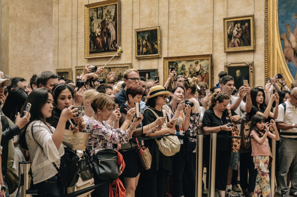 a group of tourists taking pictures in a museum 